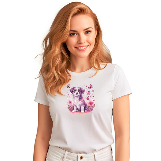 White crew neck short sleeved t-shirt, feature a tapestry of colors and a joyful cute puppy nestle in butterflies and floral garden. Female model shown in close-up to highlight print and fit.