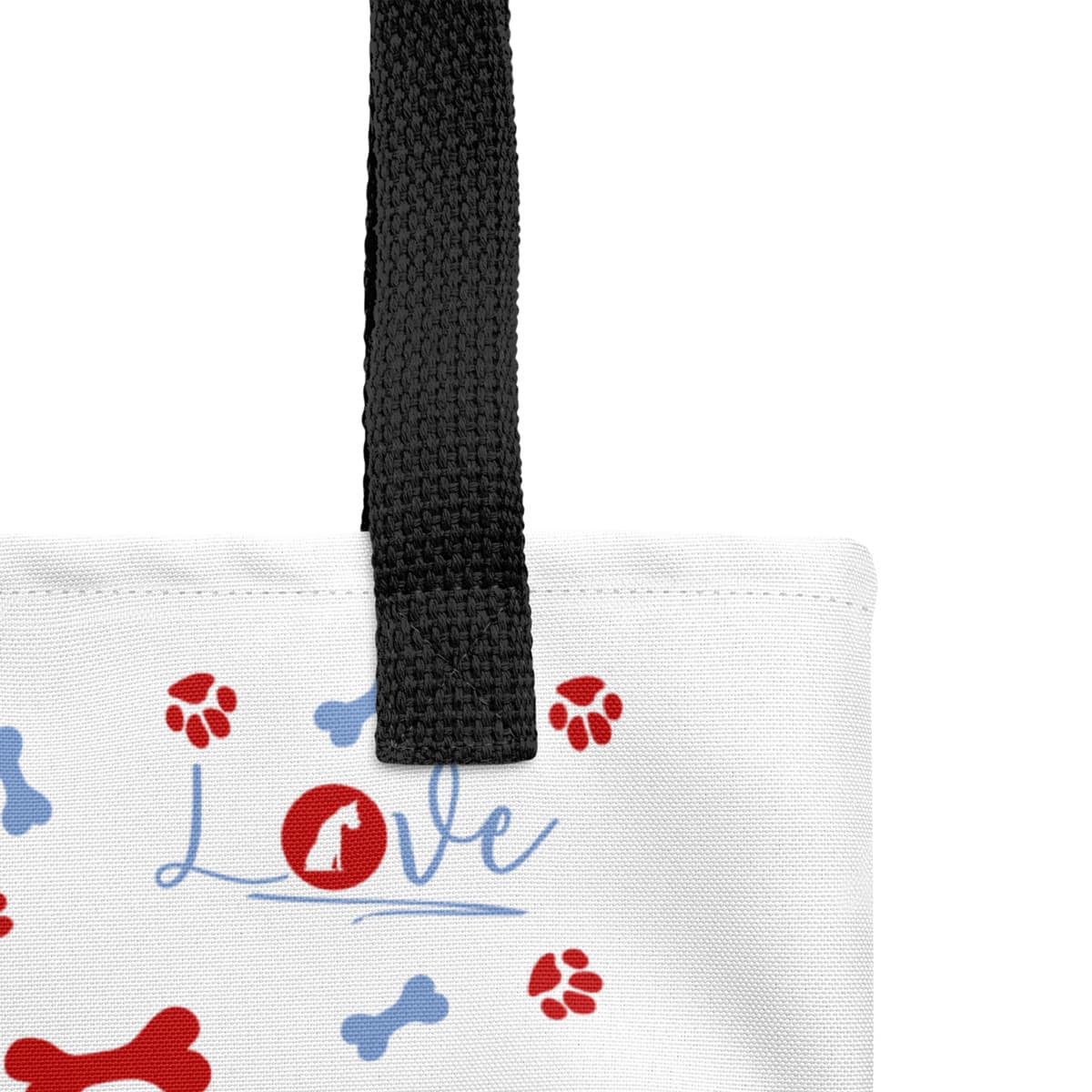 Close up of seams and stitch of a Uni-size 15"x15" white tote polyester canvas bag, with black stripped handle, feature a striking black handle striping and an eye-catching graphic of playful dog bones, paws, and the word "love," with a sitting dog as the logo.