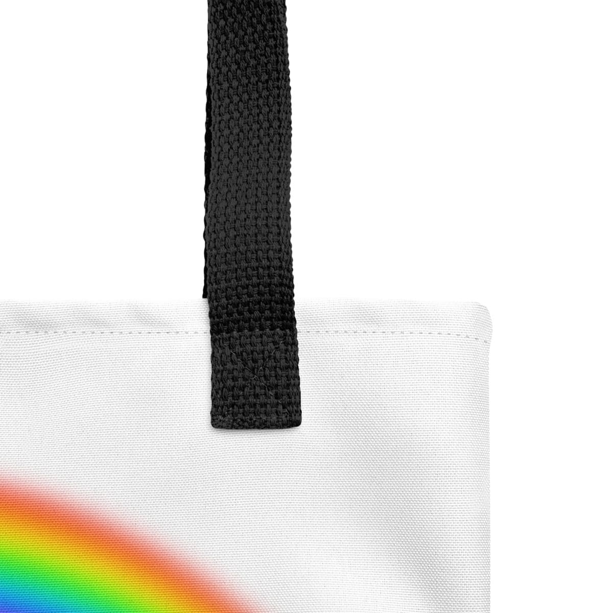 Close up of seams and stitch of a white spun canvas fabric tote bag, with black handle stripped, on the tote is a cute graphic cartoonist puppy dog sitting with a happy face, surrounded by colorful sizes butterflies, above is a colorful rainbow "