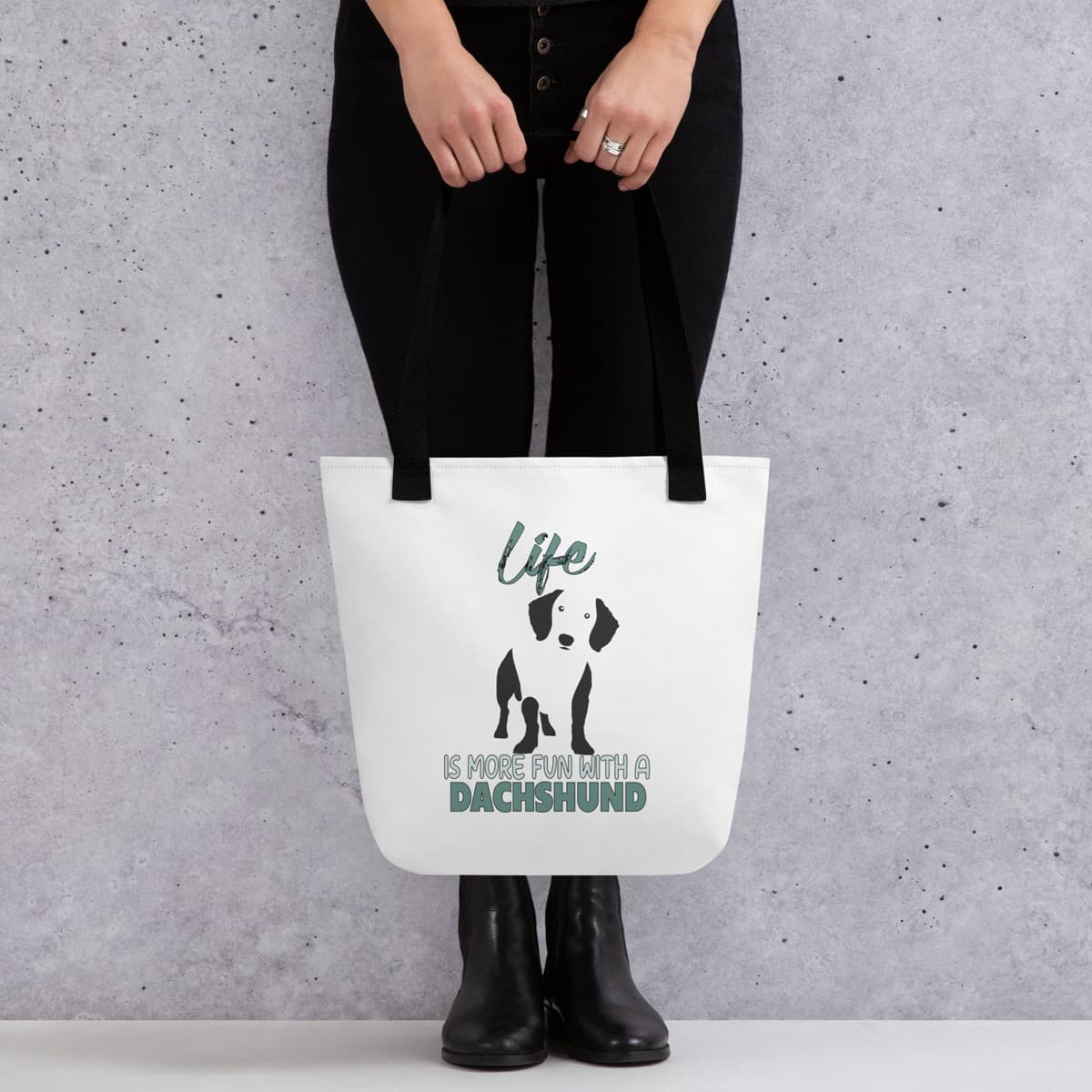 Uni-size 15"x15" white tote polyester canvas bag, with black stripped handle, feature a black one-line Dachshund print with life quote ”life is more fun with a Dachshund”. Printed front and back.