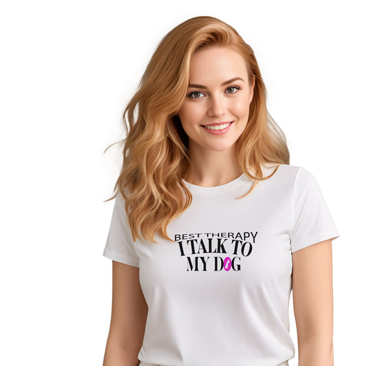 White crew neck short sleeved t-shirt, feature a graphic ”best therapy i talk to my dog” quote a cross chest. Female model shown in close-up to highlight print and fit.
