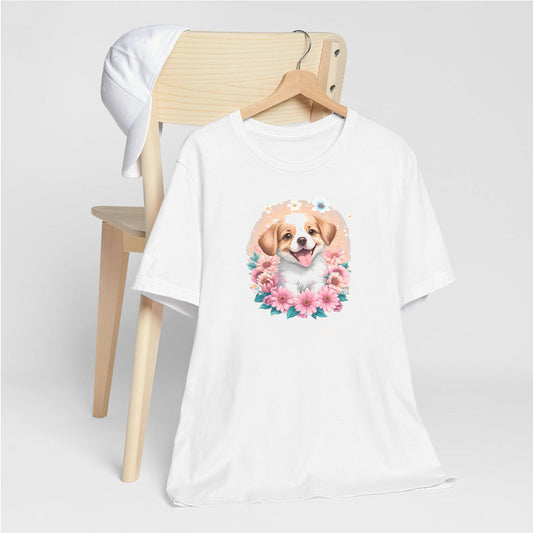 White crew neck short sleeved t-shirt, feature a graphic vibrant colorful hand-drawn dog face of a  Cavalier King Charles spaniel Puppy sitting in floral wreath. T-shirt hanging on chair shown in close-up to highlight print and size