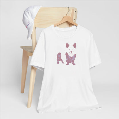 White crew neck short sleeved t-shirt, features a charming Corgi silhouette with floral, and patterned design. hanger on chair. T-shirt hanging on chair shown in close-up to highlight print and size

