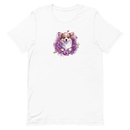 White crew neck short sleeved t-shirt, feature a graphic vibrant colorful hand-drawn Corgi puppy nestled amidst a garden of hearts and flowers in a charming wicker basket.
