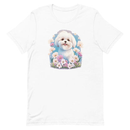 
White crew neck short sleeve t-shirt with a colorful hand-drawn Coton de tulear puppy graphic sitting in a floral garden.