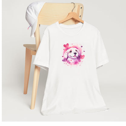 White crew neck short sleeved t-shirt, features an adorable Golden Retriever puppy, bursting of vibrant purples and pinks palette, splash with artistry hearts. T-shirt hanging on chair shown in close-up to highlight print and size