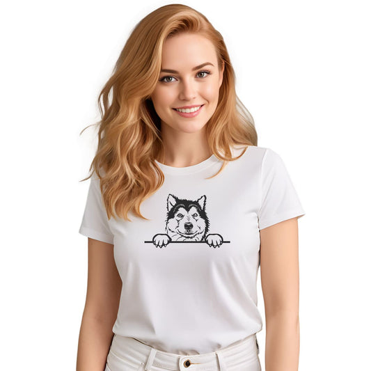 White crew neck short sleeved t-shirt. Showcase an adorable black/white hand-drawn graphic Malamute dog face resting on a table. Female model shown in close-up to highlight print and fit.