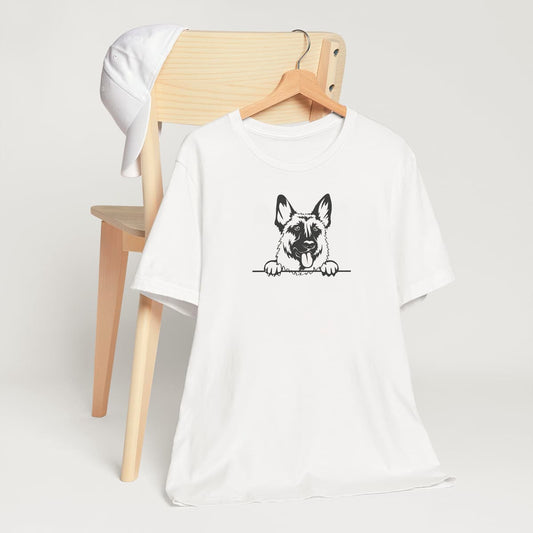 White crew neck short sleeved t-shirt, featuring a cute black and white one-line hand-drawn graphic of a German Shepherd dog face placing its paws on the table. T-shirt hanging on chair shown in close-up to highlight print and size