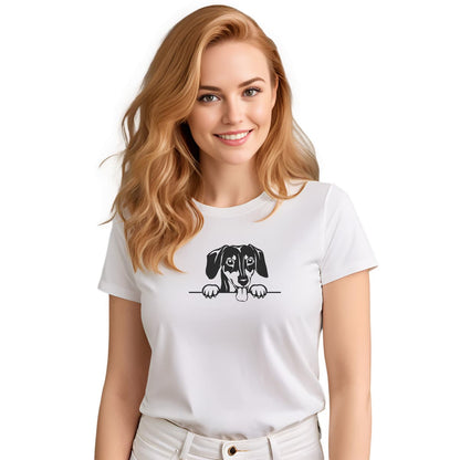 White crew neck short sleeved t-shirt, feature a cute one-line hand- drawn black/white graphic Dachshund dog face, resting paws on the table. Female model shown in close-up to highlight print and fit.