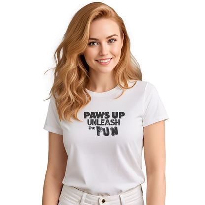 White crew neck short sleeved t-shirt, featuring a playful "paws up unleash the fun" black graphic. Female model shown in close-up to highlight print and fit.
