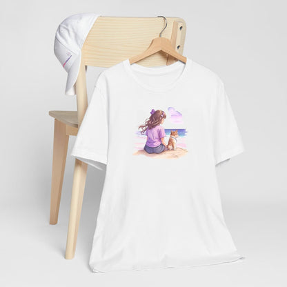 hite crew neck short sleeved t-shirt, featuring a vivid hand-drawn puppy and a girl sharing a moment on a beach, surrounded by dark reds, purples, and pinks on a pristine white background. T-shirt hanging on chair shown in close-up to highlight print and size
