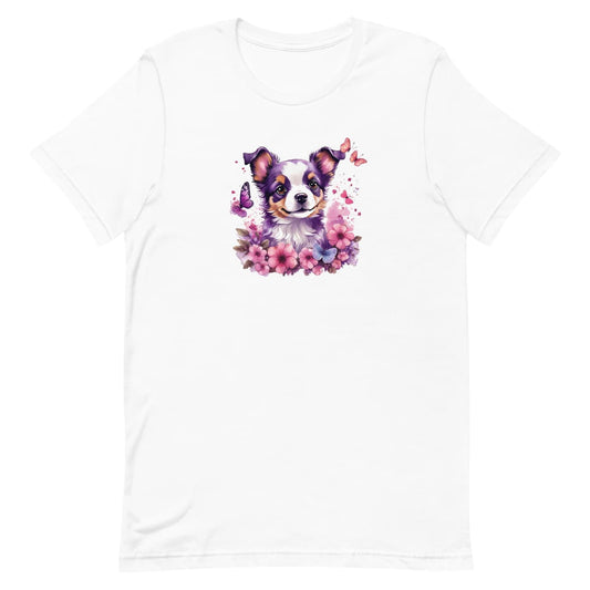 White crew neck short sleeved t-shirt, showcases a puppy face, nestled amidst a lush floral arrangement within a wicker basket.