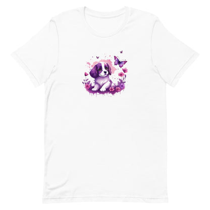 White crew neck short sleeved t-shirt, feature an Spaniel puppy, the epitome of adorable, frolicking amidst a kaleidoscope of blooms in a charming wicker basket. 