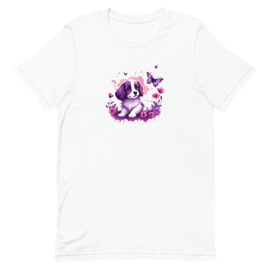 White crew neck short sleeved t-shirt, feature an Spaniel puppy, the epitome of adorable, frolicking amidst a kaleidoscope of blooms in a charming wicker basket. 