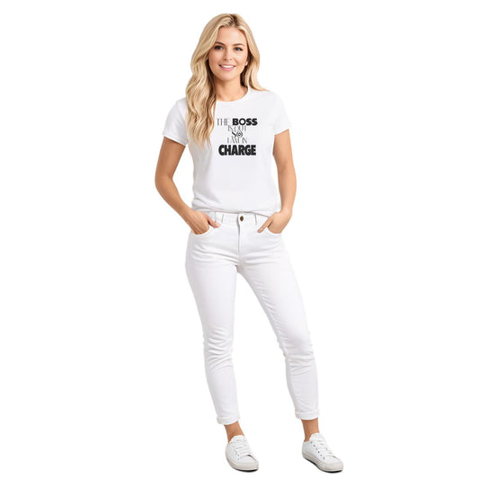 White crew neck short sleeved t-shirt, features a playful message "the boss is out so i am in charge" in bold black graphic style, underlined by a dog paw. Female model shown in close-up to highlight print and fit.