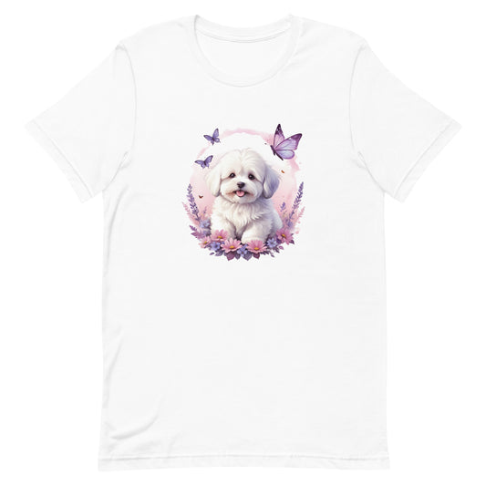 White cotton crew neck unisex short sleeve tshirt, on the apparel is a detailed kawaii illustration print of a lively cute adorable coton de tulear surrounded by floral arrangement in a wicker basket. The design brings a touch of color, warmth, and charm in pastel color palette to the shirt print.