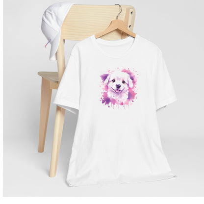 White crew neck short sleeved t-shirt. Featuring an enchanting Maltese puppy amidst a tapestry of splash artistry in vibrant pink and purple toned colors. T-shirt hanging on chair shown in close-up to highlight print and size