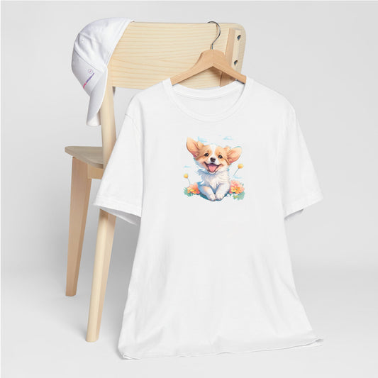 
White crew neck short sleeved t-shirt, feature a graphic vibrant colorful hand-drawn happy Corgi puppy nestled amidst of flowers. T-shirt hanging on chair shown in close-up to highlight print and size.