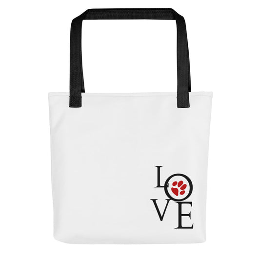 Front side of a Uni-size 15"x15" white tote polyester canvas bag, with black stripped handle, featuring an artistry graphic ”LOVE” with a cute red dog paw in the letter ”o”.