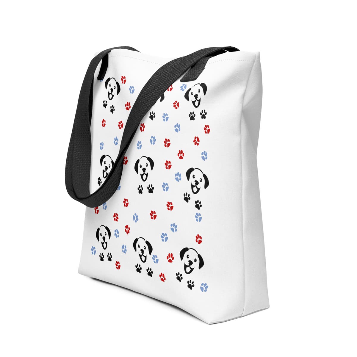 White spun canvas fabric tote bag, with black handle stripped, on the tote is a cute graphic cartoonist happy puppy face, surrounded by colorful paws.