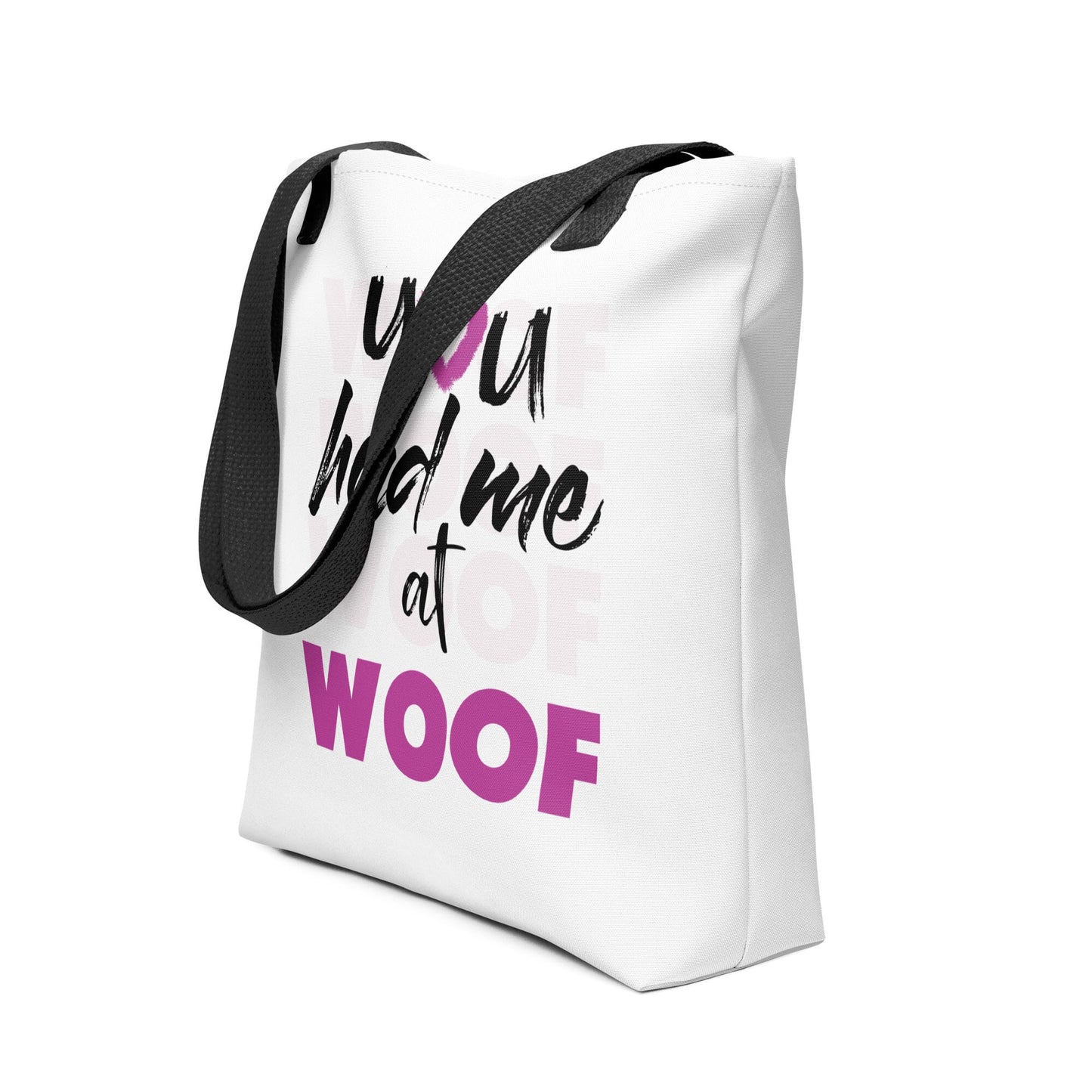 Unisize 15"x15" white tote bag, with black stripped handle, feature a classic quote you had me at woof, the letter o, is a pink colred heart with dog paw, there is underlay of thentext woof, repeated several times.