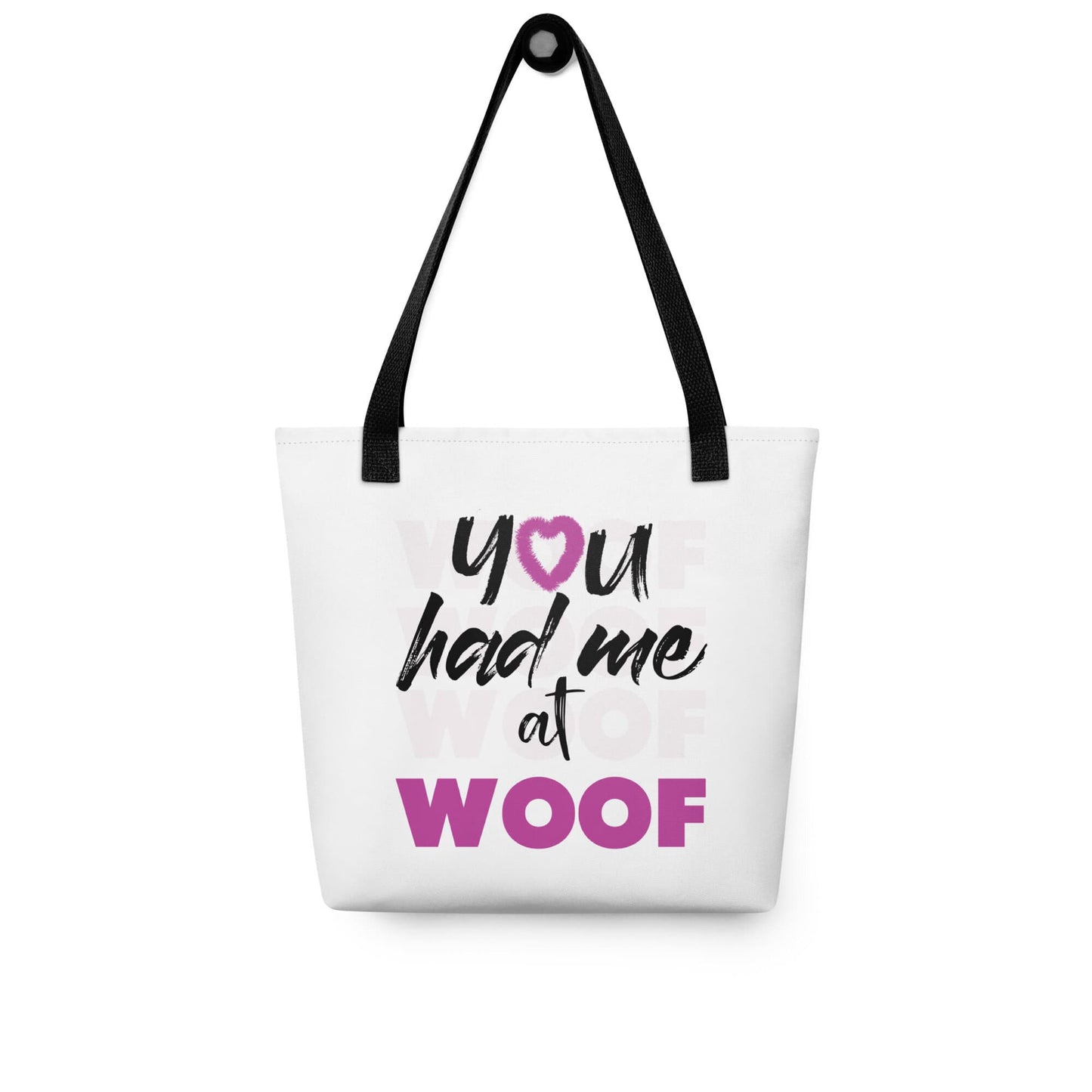 Unisize 15"x15" white tote bag, with black stripped handle, feature a classic quote you had me at woof, the letter o, is a pink colred heart with dog paw, there is underlay of thentext woof, repeated several times. Printed front and back.