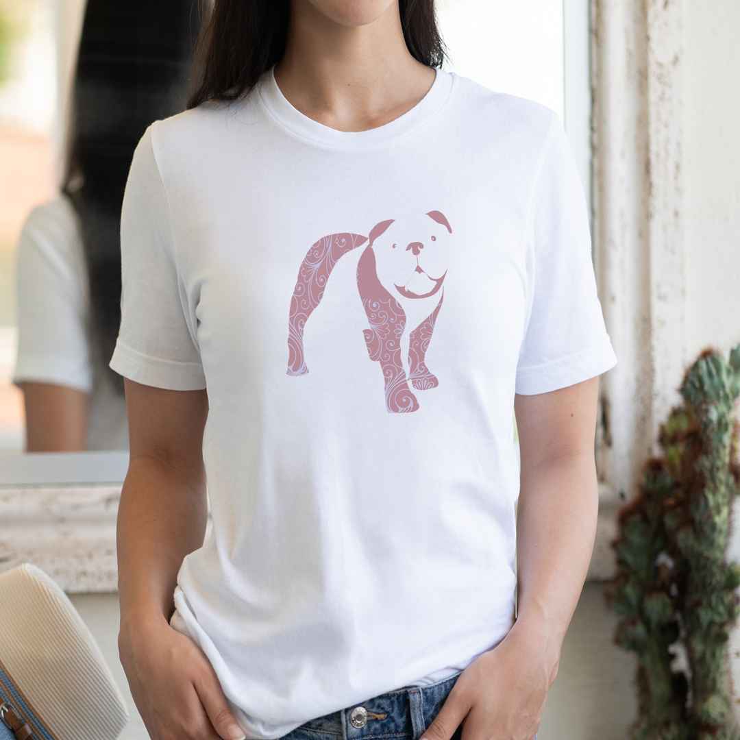 White cotton crew neck unisex  short sleeve tshirt, on the apparel is a graphic print silhouette of a cute Bulldog standing with its tongue out, the silhouette is with flowers and patterns in colors pastel and purple, reminds a bit of flower power