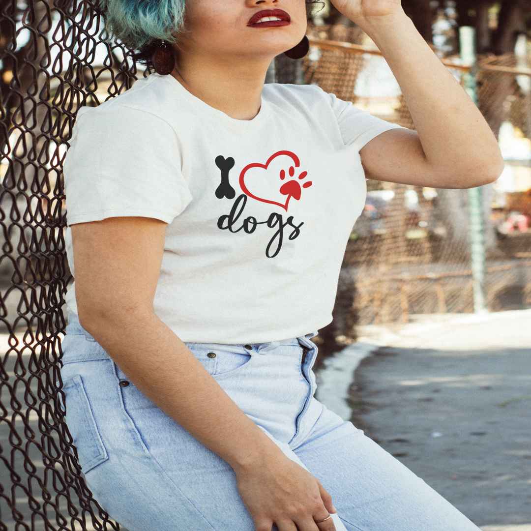 White cotton crew neck unisex  short sleeve tshirt, on the apparel is a graphic Dog bone as in "I" and a graphic shaped red heart and paw, underneath is the "dogs" written in graphic letters.