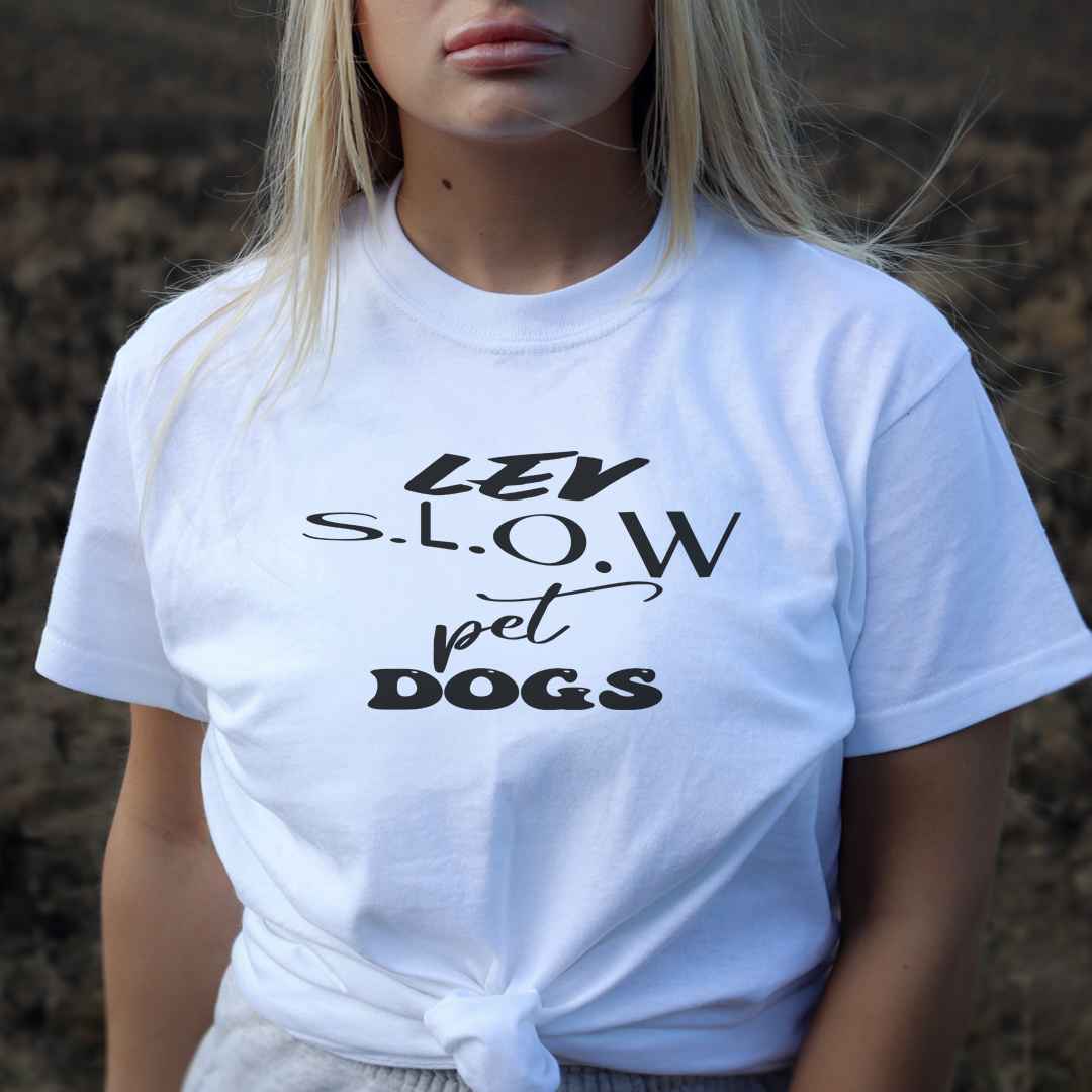 White cotton crew neck unisex  short sleeve tshirt, on the apparel is a graphic black/white text  saying "lev s.l.o.w pet dogs"