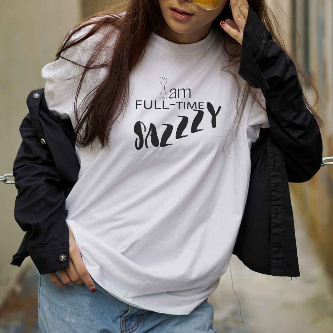  White cotton crew neck unisex  short sleeve tshirt, on the apparel is a graphic Dog bone as in I and a graphic text saying "am full-time sazzzy,  in cap.