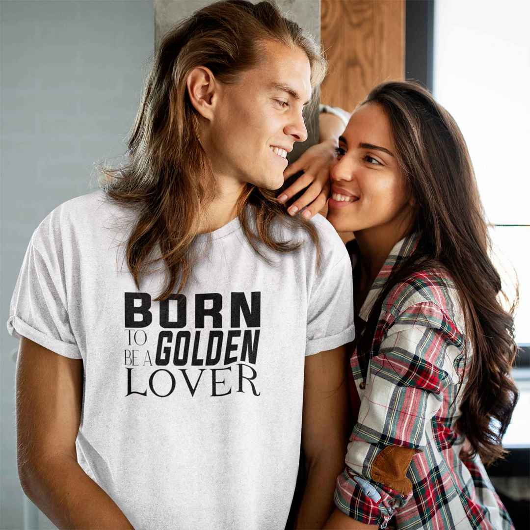 White cotton crew neck unisex shirt, short sleeve, on the apparel is a black and white graphic print with the text BORN TO BE A GOLDEN LOVER in capital letters in different text styles