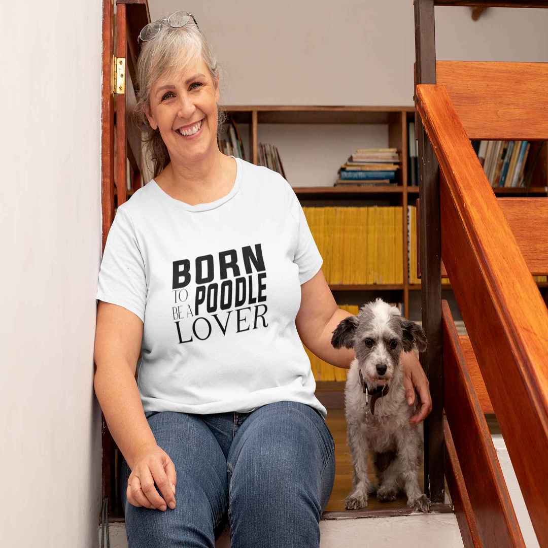 White cotton crew neck unisex  short sleeve tshirt, on the apparel is a black and white graphic print with the text BORN TO BE A POODLE in capital letters in different text styles