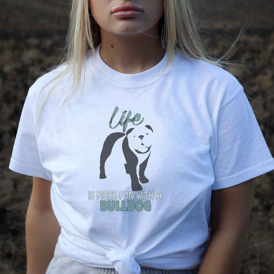 Women standing, wearing a white crew neck short sleeved t-shirt, features a charming bulldog silhouette with playful quote; Life is more fun with a Bulldog” across chest. Female model shown in close-up to highlight print and fit.