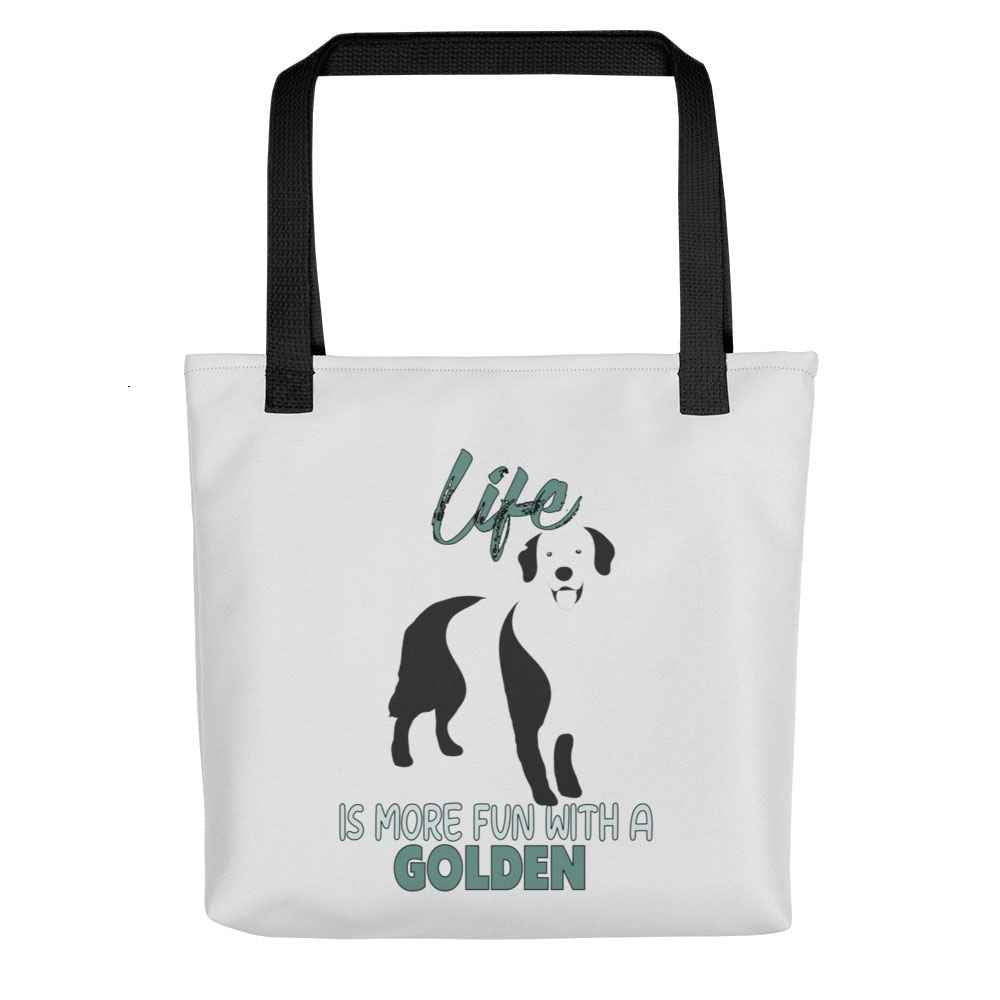 White spun canvas fabric tote bag , on the bag is a black one-line graphic print silhouette of a cute Golden Retriever dog standing with its tongue out. Above the dog is the text " LIFE" in cap and underneath the dog is the text " is more fun with a Golden " in cap"