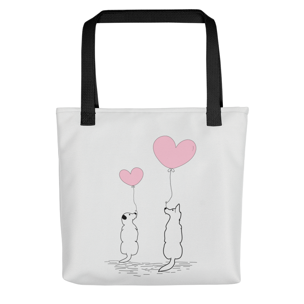 White spun canvas fabric tote bag, with black handle stripped, on the tote is two graphic dogs sitting beside each other. facing each other, with each a pink ballon, holding it string, the theme for this tote is "love is in the air"