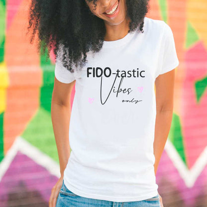 White cotton crew neck unisex  short sleeve tshirt, on the apparel is a graphic black text  saying "fido-tastic vibes only" on both sides are pink hearts.