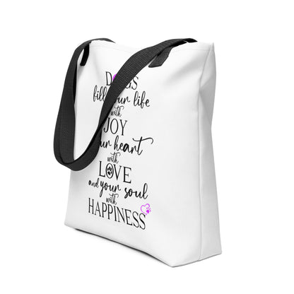 White spun canvas fabric tote bag, with black handle stripped, on the tote is  graphic quote saying" dogs fill your life with joy, your heart with love and your soul with happiness"