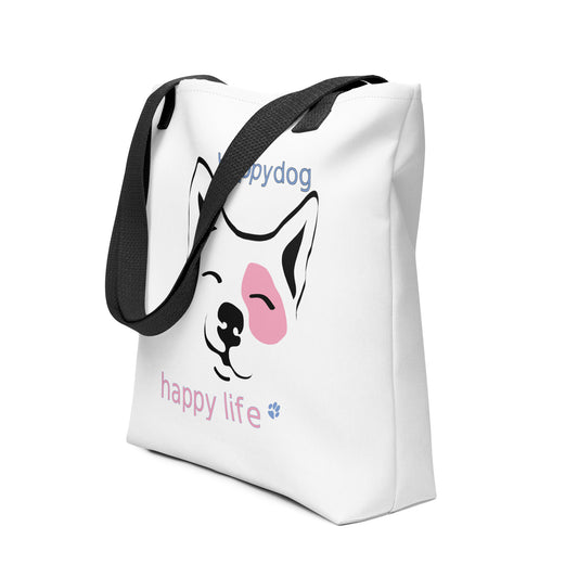 White spun canvas fabric tote bag, with black handle stripped, on the tote is is a graphic print with a cute corgi face, squint eyes happy face above the dog face is reading the text "happy dog” and below is the text "happy life ", the graphic designed print is in colors, white, black and pink