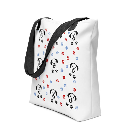 White spun canvas fabric tote bag, with black handle stripped, on the tote is a cute graphic cartoonist happy puppy face, surrounded by colorful paws