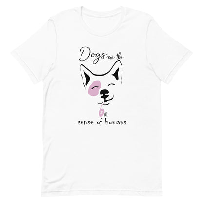 cotton crew neck shirt, short sleeved, on the apparel is a graphic print with a cute corgi face, squint eyes happy face above the dog face is reading the text "dogs are the" and below is the text "6th sense of humans", the graphic designed print is in colors, white, black and pink.