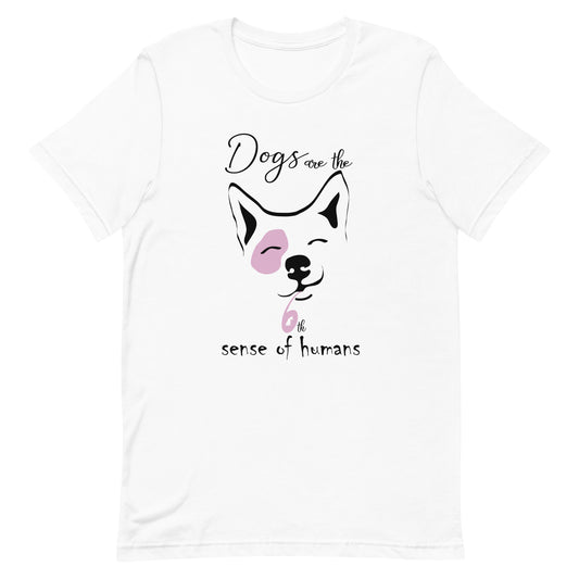 cotton crew neck shirt, short sleeved, on the apparel is a graphic print with a cute corgi face, squint eyes happy face above the dog face is reading the text "dogs are the" and below is the text "6th sense of humans", the graphic designed print is in colors, white, black and pink.