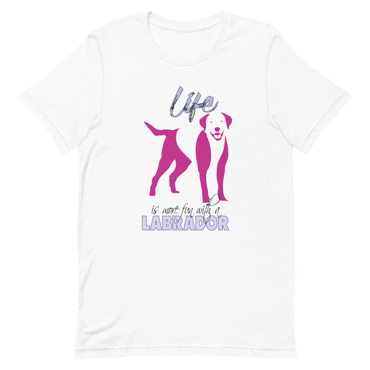 White cotton crew neck unisex  short sleeve tshirt, on the apparel is a graphic print silhouette of a cute adorable Labrador standing , the dog silhouette is in pink color, above the dog is the text " Life" written in tilted purple graphic letter, below is the text " is more fun with a Labrador" in capital letter, the text "Labrador" stands out with its pink color.