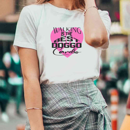 White cotton crew neck unisex  short sleeve tshirt, on the apparel is a graphic pink heart with a paw, on top of the heart is the text "Walking is the best doggo cardio