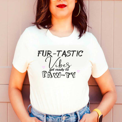 White cotton crew neck unisex  short sleeve tshirt, on the apparel is  a graphic text saying "Fur- tastic vibes get ready to paw-ty" on the side is two pink hearts.