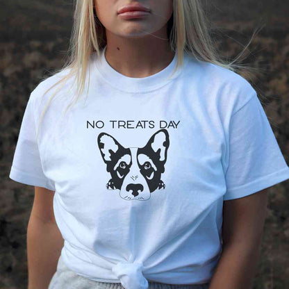 White cotton crew neck unisex  short sleeve tshirt, on the apparel is a black one-line graphic dog face resting with it paws under its head, the dog face is moody, above is the text"no treats day" in cap. 